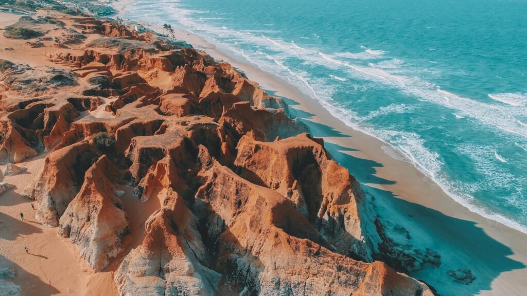 an aerial view of a sandy beach and ocean